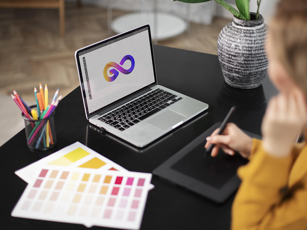 female-logo-designer-working-her-tablet-connected-laptop